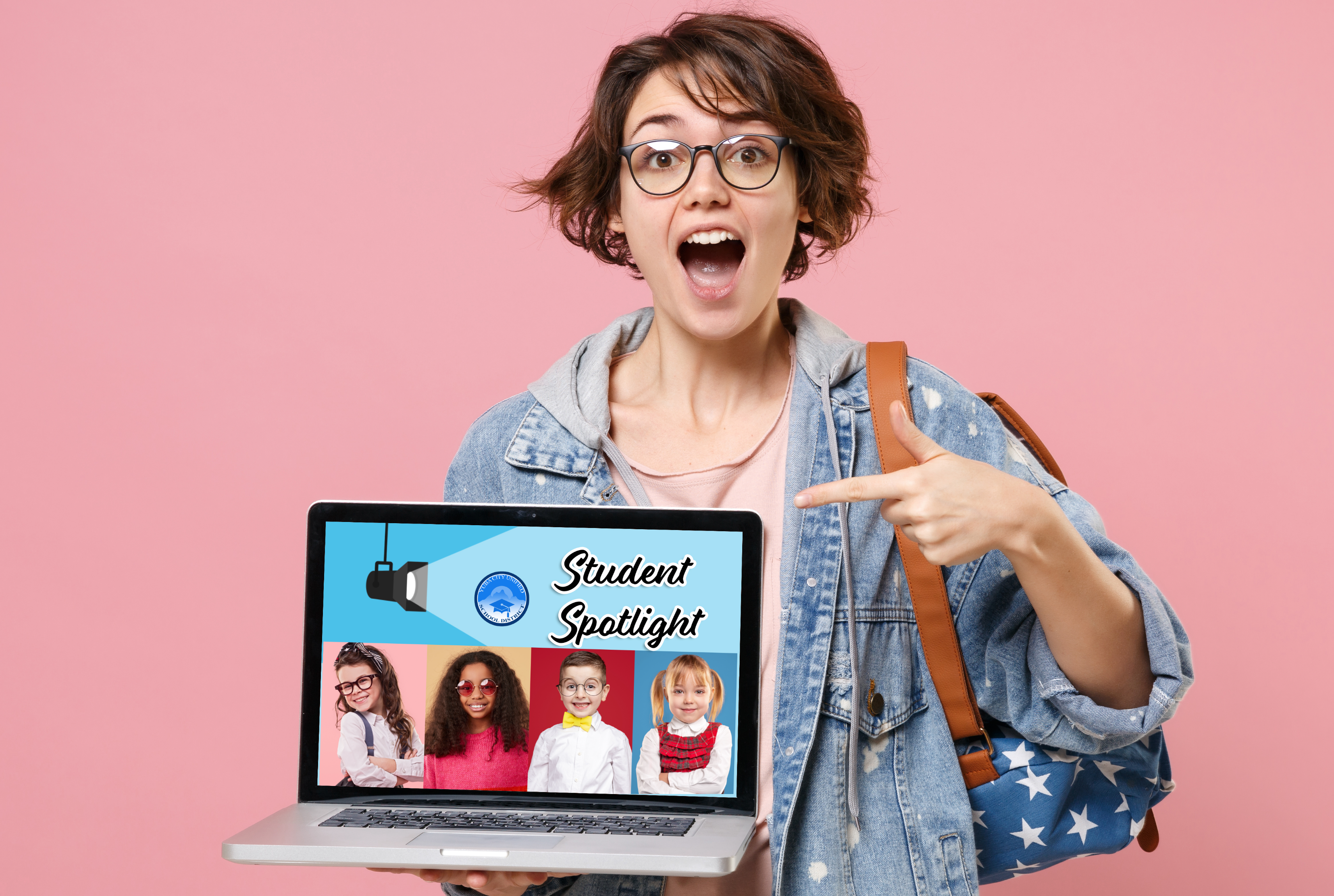 Student holding laptop with the Student Spotlight on it.